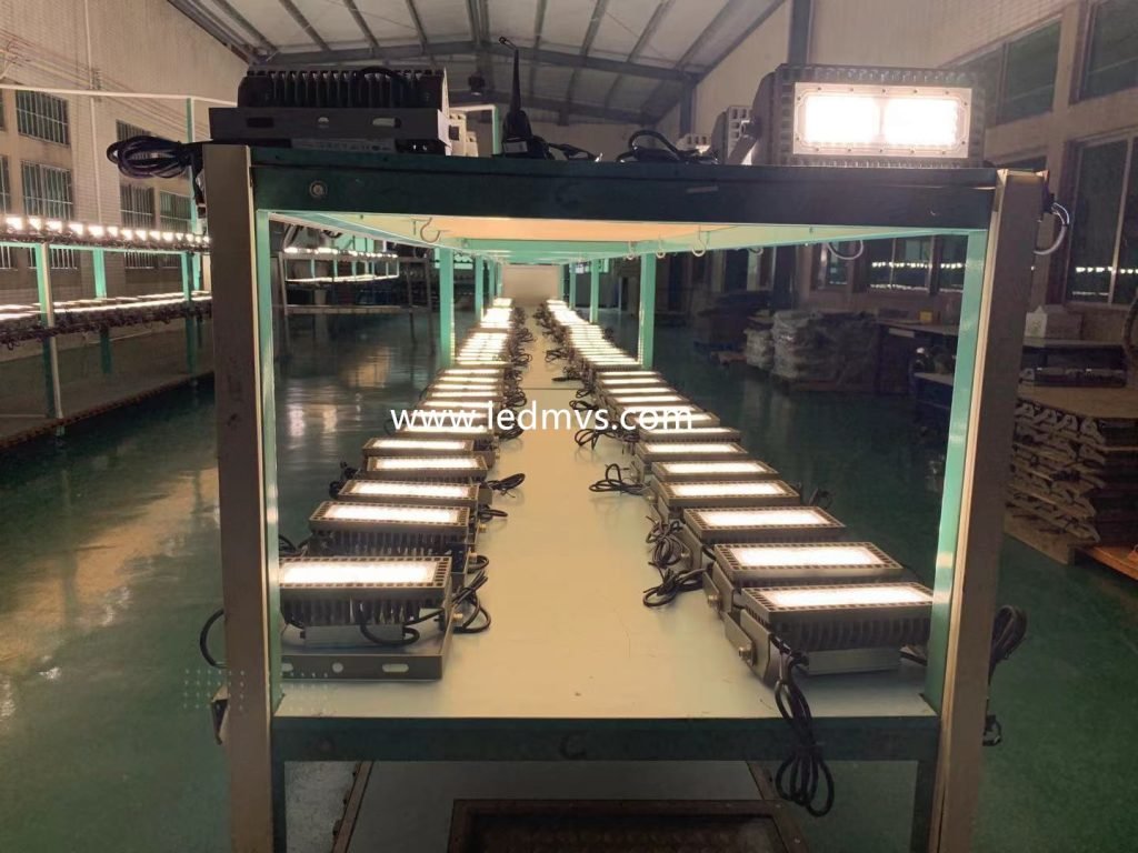 `LED floodlights undergoing burn-in testing on the MVS factory production line`
