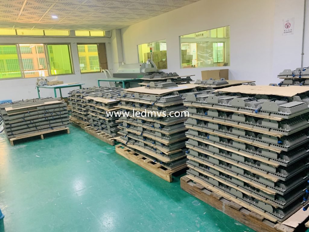 Hundreds of assembled LED street light housings are neatly stacked on pallets inside the MVS factory, ready for final testing and shipment. Each unit undergoes rigorous quality control and is built with durable components to meet a guaranteed 5-year performance standard, supporting large-scale municipal and industrial lighting projects.