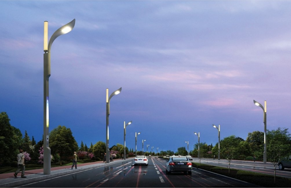 Smart streetlights with a modern, curved design lining a city roadway at dusk, equipped with energy-efficient LED lighting for enhanced visibility and reduced energy consumption. Trees and landscaped areas are visible along the road, demonstrating the integration of smart lighting in urban planning.