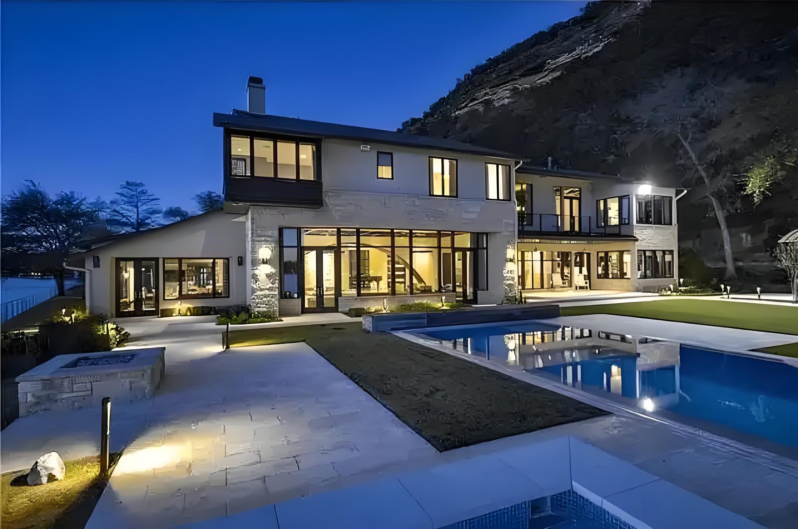 Modern residential house illuminated by LED floodlights creating a warm outdoor atmosphere