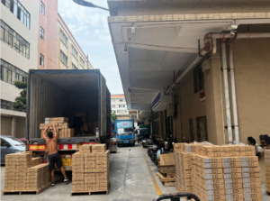 LED floodlight cartons being loaded into an export container at a lighting factory in China